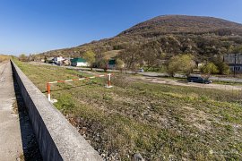 Pohled na Malý Ťačiv z protipovodňového valu u Tisy, v pozadí vrch Neresenul Mare patřící do Ignišských hor (2025)